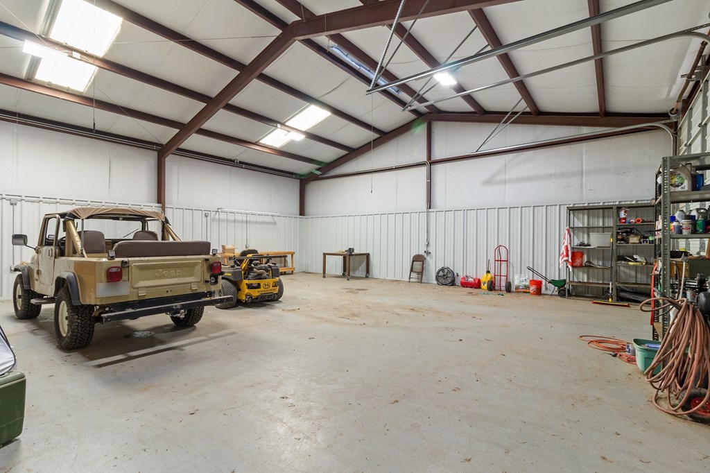 647 Funf Kinder Road Fredericksburg, TX 78624 - Photo 77 of 100 a view of a garage with parked cars