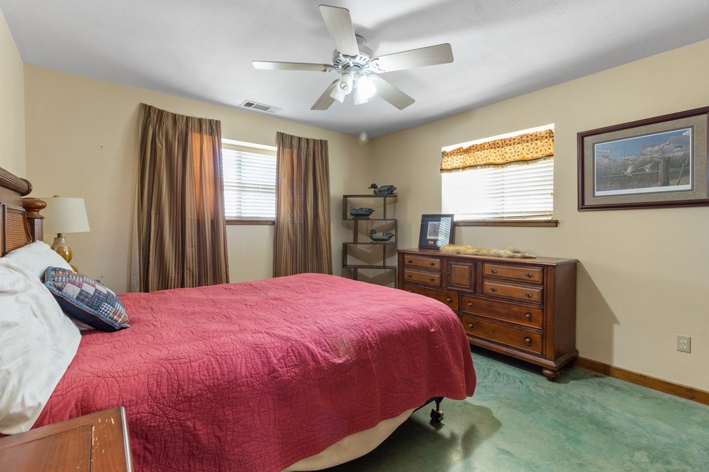 647 Funf Kinder Road Fredericksburg, TX 78624 - Photo 86 of 100 a bedroom with a bed and a dresser