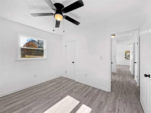 a view of empty room with wooden floor