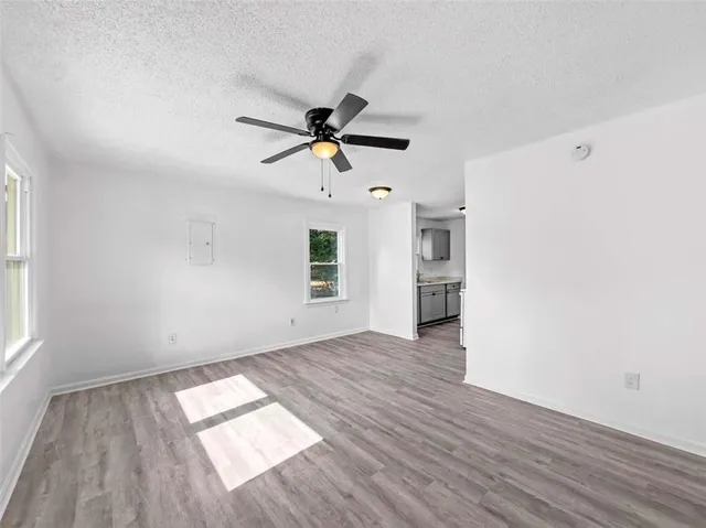 wooden floor in an empty room with a window