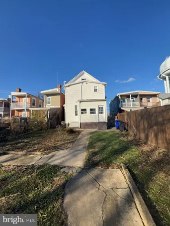 a view of a white house with a yard