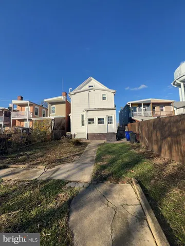 a view of a white house with a yard