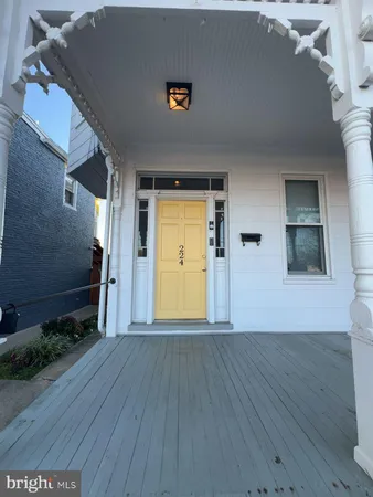 a view of a livingroom with wooden floor and a ceiling fan