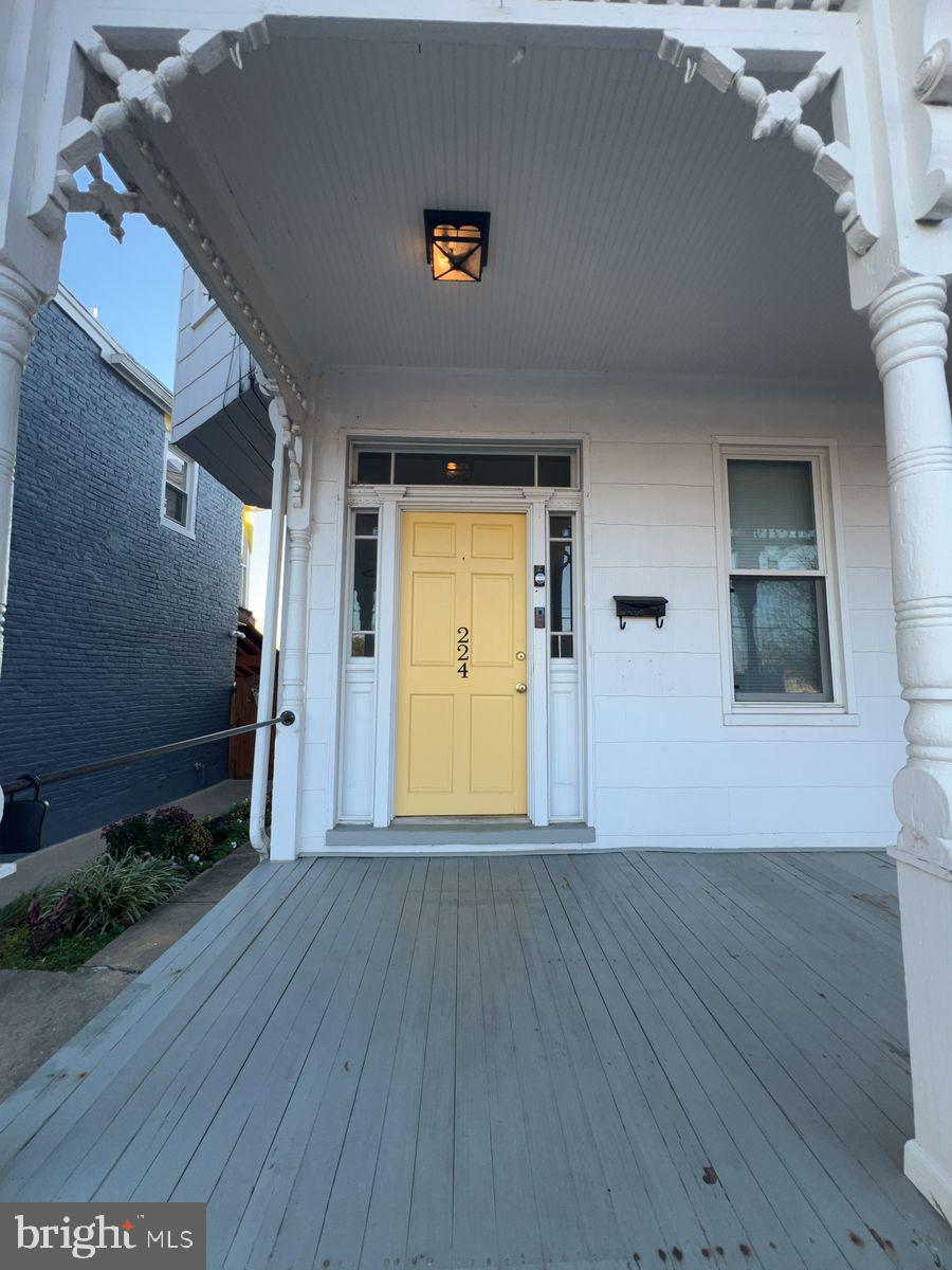 224 South Carroll Street, Unit 1 Frederick, MD 21701 - Photo 2 of 12 a view of a livingroom with wooden floor and a ceiling fan