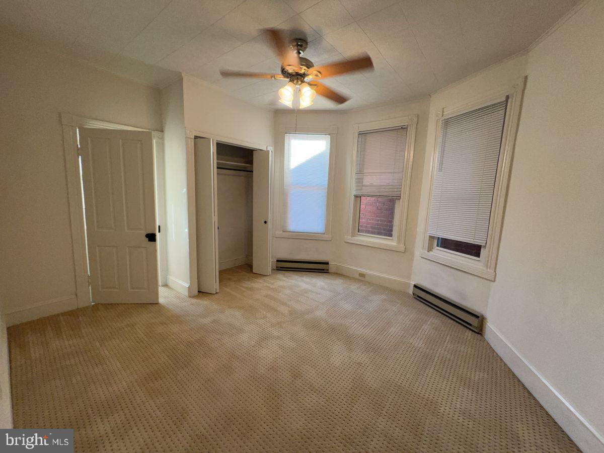 224 South Carroll Street, Unit 1 Frederick, MD 21701 - Photo 7 of 12 a view of a livingroom with a ceiling fan and window
