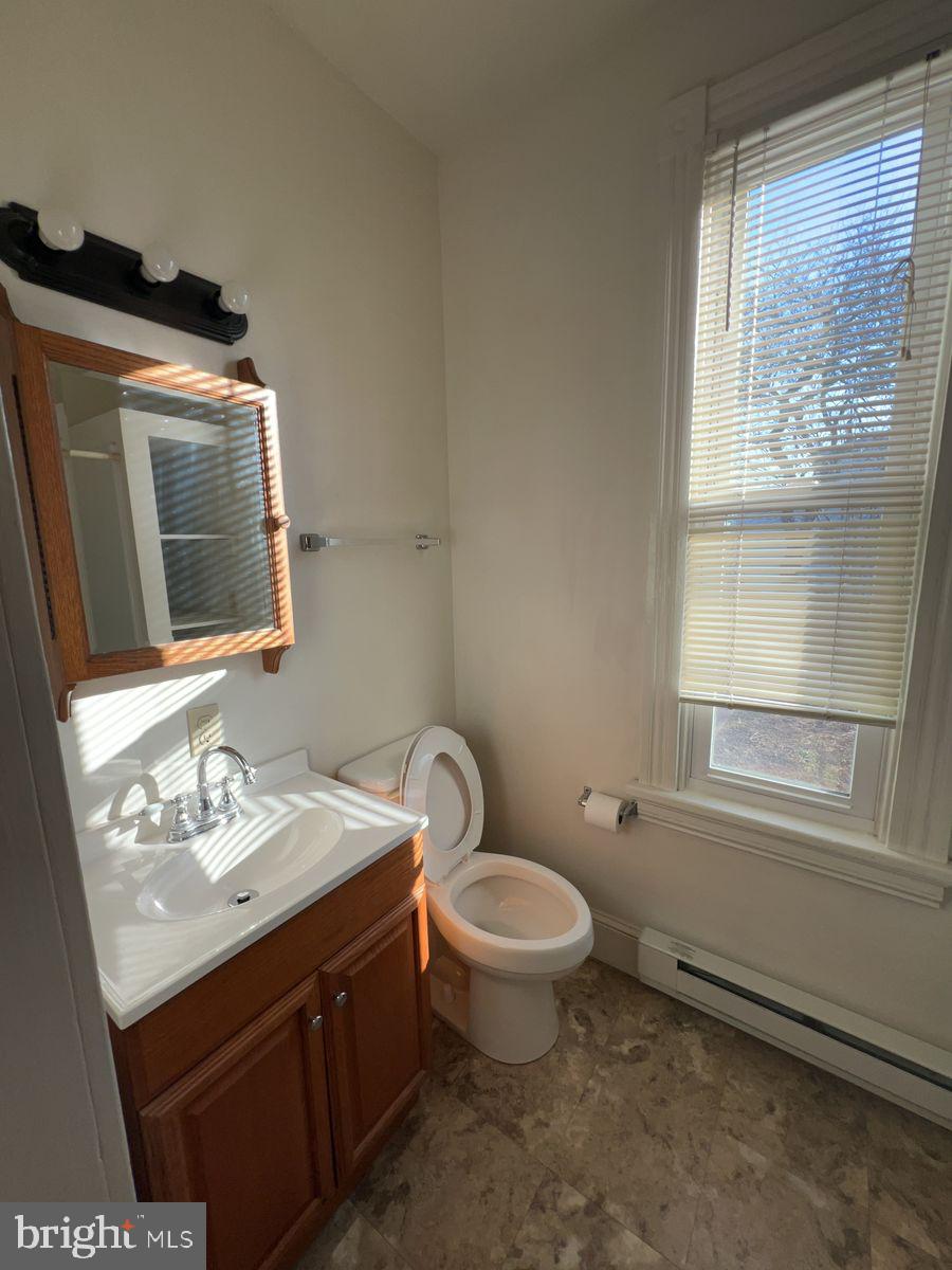 224 South Carroll Street, Unit 1 Frederick, MD 21701 - Photo 8 of 12 a bathroom with a sink toilet and window