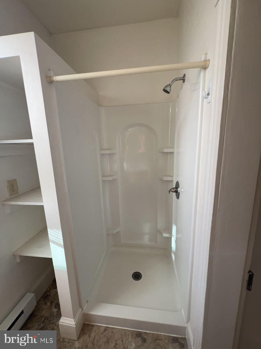 224 South Carroll Street, Unit 1 Frederick, MD 21701 - Photo 9 of 12 a bathroom with a glass shower door