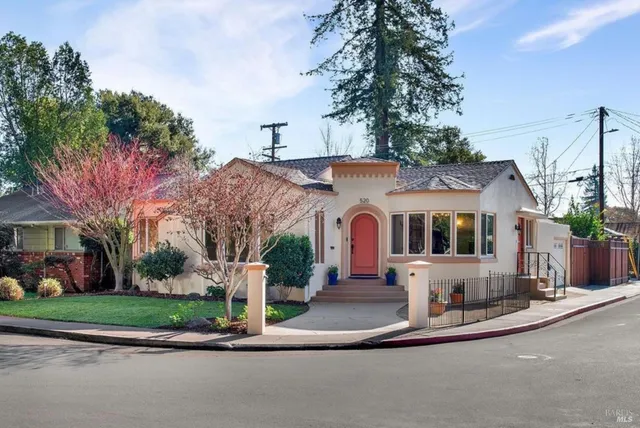 a front view of a house with a yard and fountain