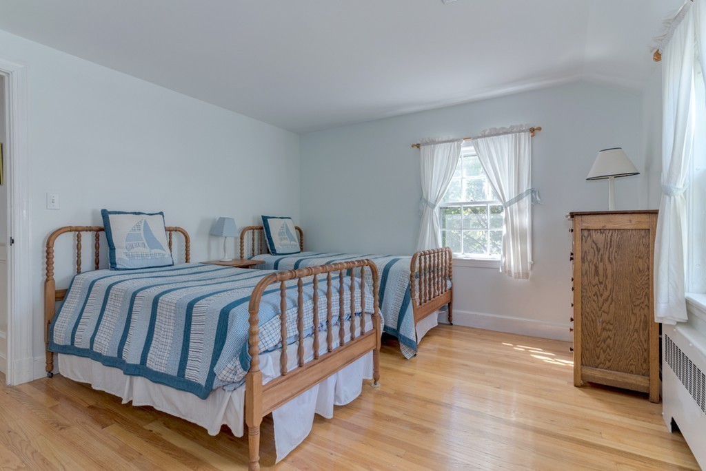 76 Clifton Road Milton, MA 02186 - Photo 16 of 28 a bedroom with a bed and wooden floor