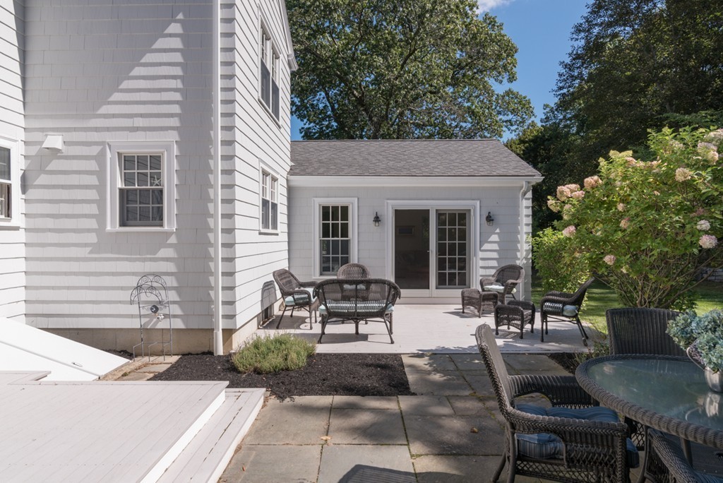 76 Clifton Road Milton, MA 02186 - Photo 25 of 28 a view of a patio with table and chairs and potted plants