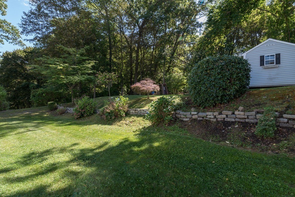 76 Clifton Road Milton, MA 02186 - Photo 27 of 28 a backyard of a house with lots of green space