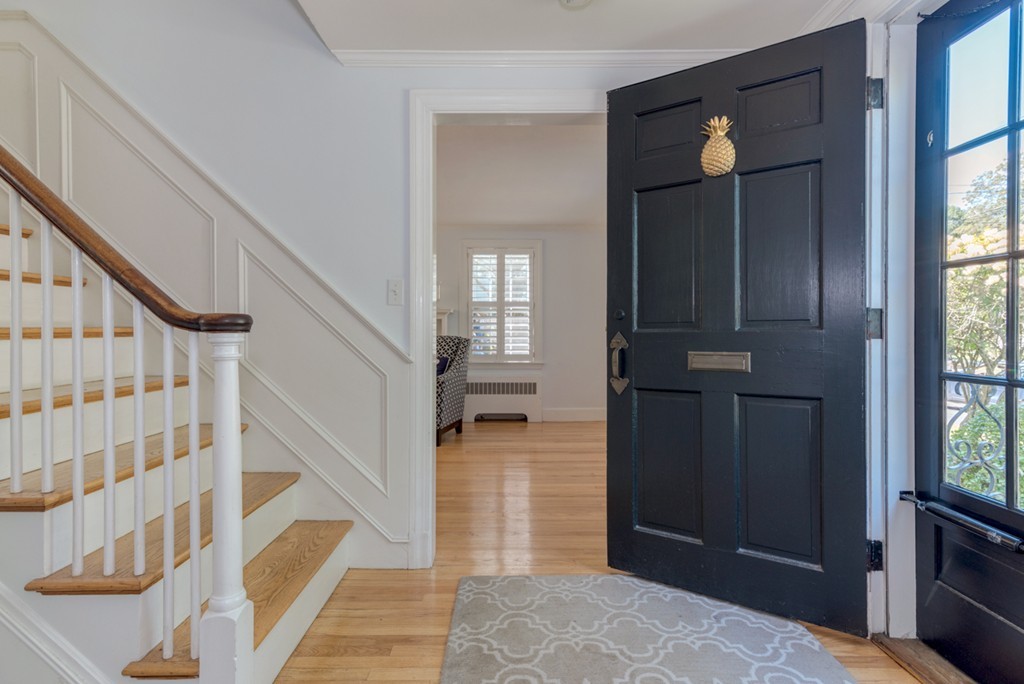 76 Clifton Road Milton, MA 02186 - Photo 3 of 28 a view of a hallway with wooden floor and staircase