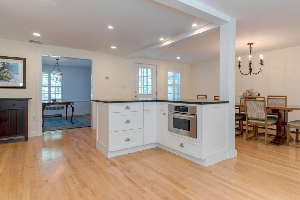 76 Clifton Road Milton, MA 02186 - Photo 7 of 28 a kitchen with stainless steel appliances kitchen island granite countertop a stove a sink and a refrigerator