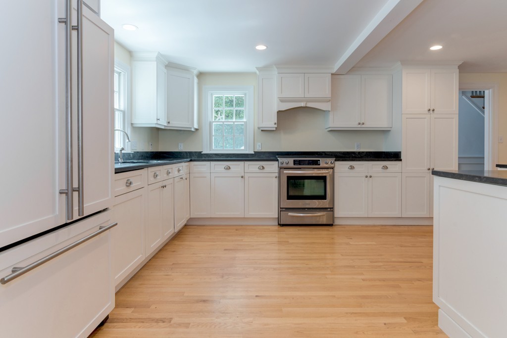 76 Clifton Road Milton, MA 02186 - Photo 8 of 28 a kitchen with stainless steel appliances granite countertop a stove sink and cabinets
