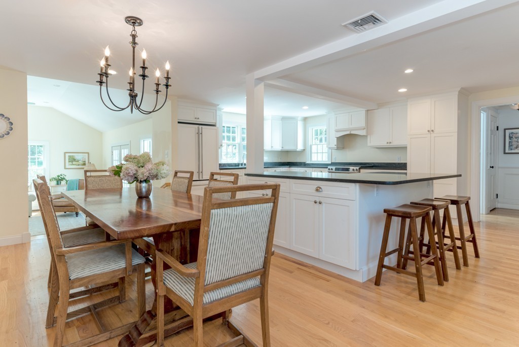 76 Clifton Road Milton, MA 02186 - Photo 10 of 28 a dining room filled chandelier and kitchen view