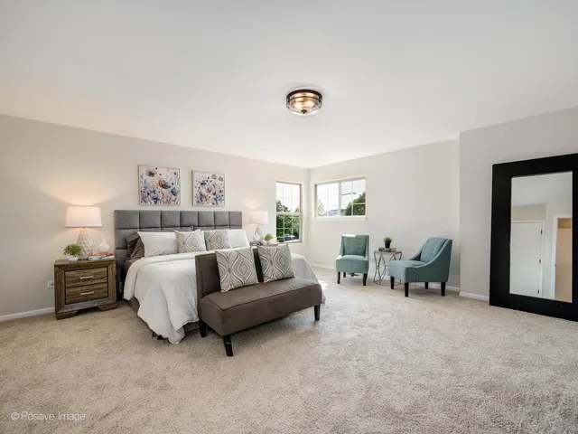 a spacious bedroom with a bed and a couch