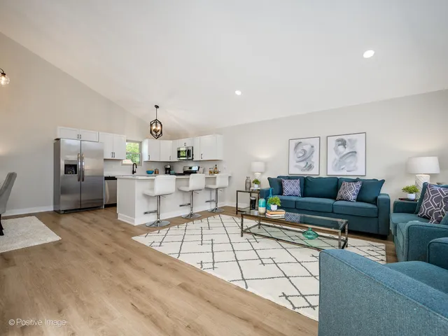 a living room with furniture and kitchen view