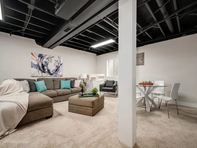 a living room with furniture a fireplace and a table