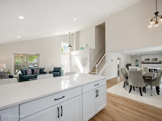 a view of a kitchen counter space with furniture and wooden floor