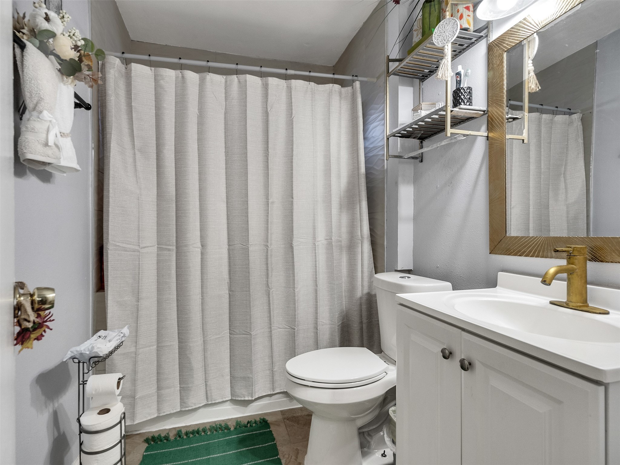 6802 Force Street Houston, TX 77020 - Photo 22 of 31 a bathroom with a sink a toilet and shower curtain