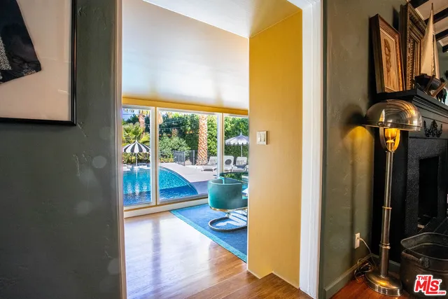 a living room with fireplace furniture and a large window