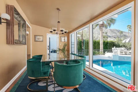 a living room with furniture a rug and a large window