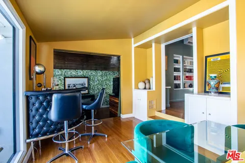 a living room with furniture and a floor to ceiling window