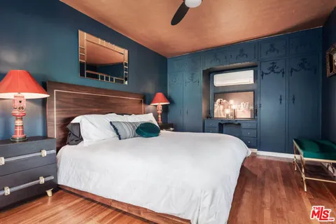 a view of a hallway with wooden floor and a fireplace