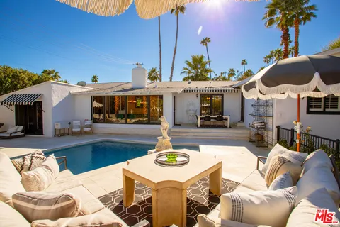 a view of a patio with swimming pool table and chairs