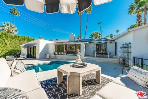 a front view of a house with a yard table and chairs