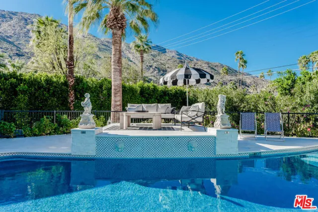 a view of a swimming pool with chairs