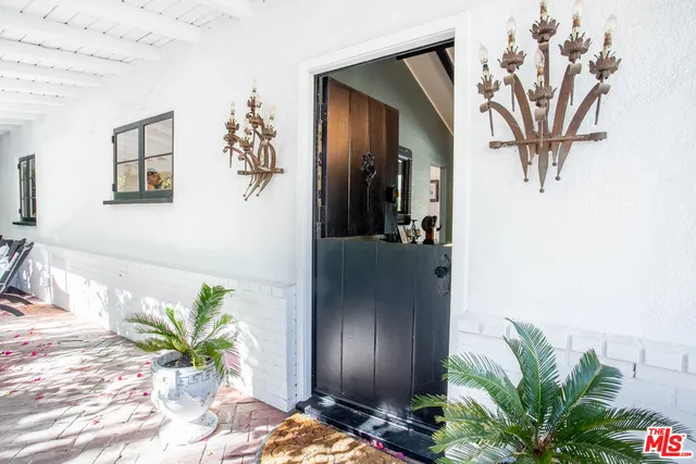 a white vase with flowers