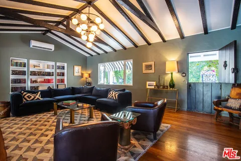 a living room with furniture and wooden floor