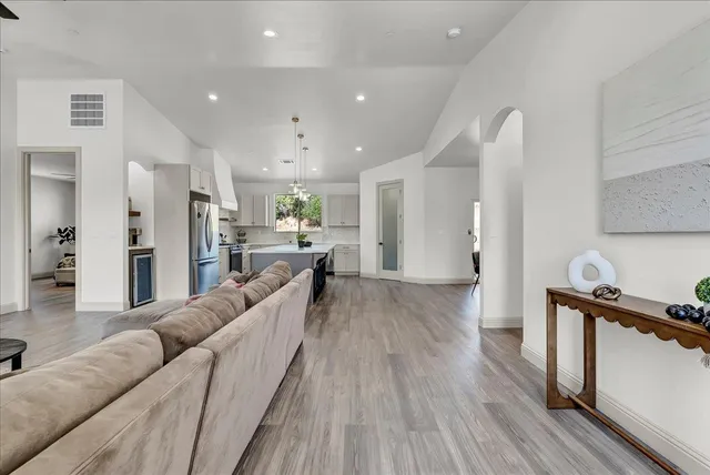 a living room with furniture and a wooden floor