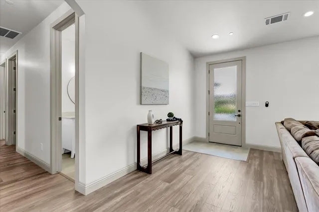 a view of a room with wooden floor and furniture
