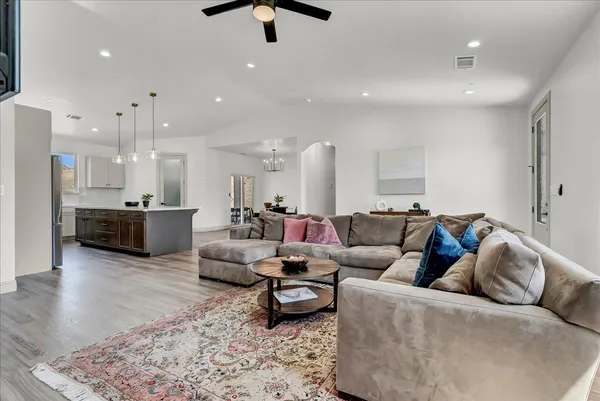 a living room with furniture and kitchen view