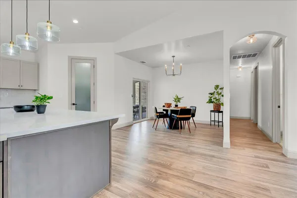 a view of a dining room with furniture and wooden floor