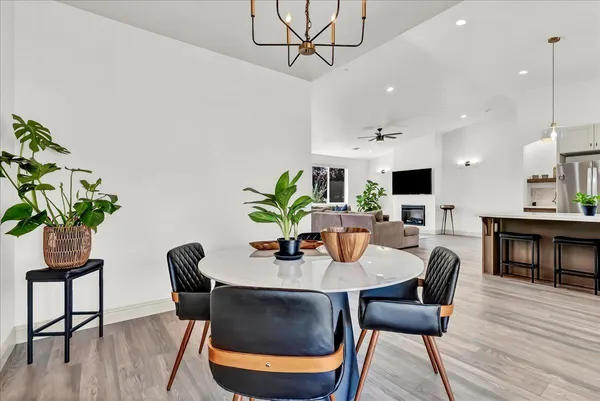 a dining room with furniture potted plants and wooden floor