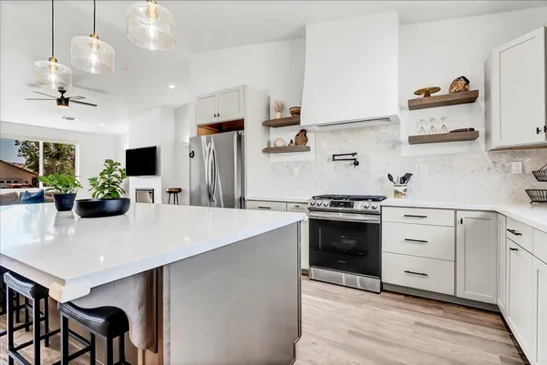 a kitchen with a white cabinets and appliances