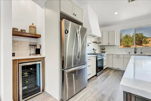 a kitchen with white cabinets and stainless steel appliances