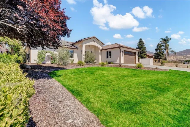 a front view of a house with garden
