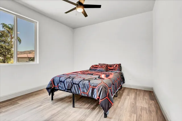 a bedroom with a bed and wooden floor