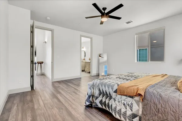a bedroom with a bed and wooden floor