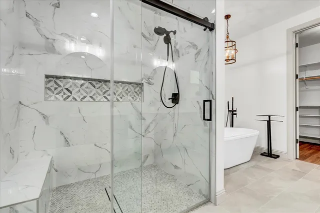 a bathroom with a toilet and a shower