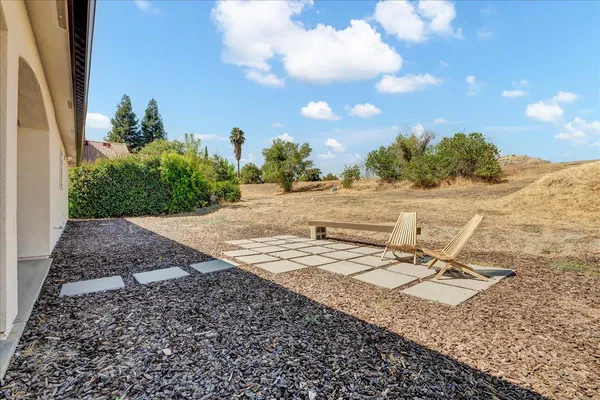 a view of a house with backyard and sitting area