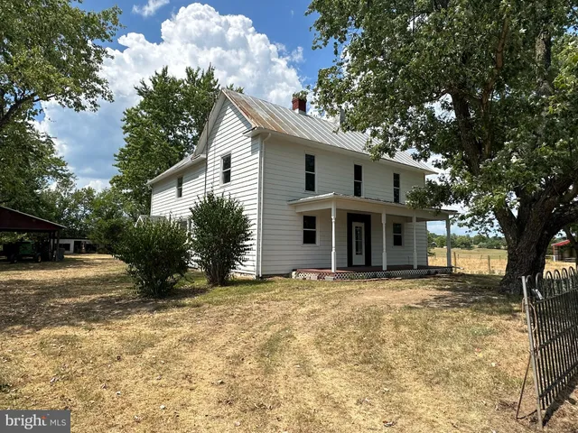a view of a house with a tree in the yard