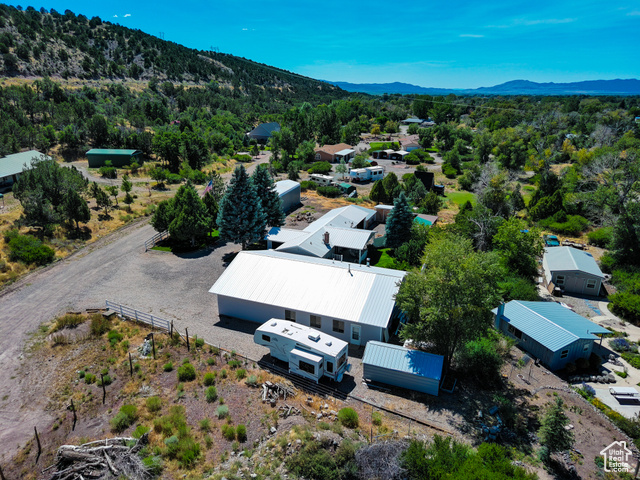 2373 East 190 North Beaver, UT 84713 - Photo 10 of 54 Aerial view of property and surrounding area featuring a forest and a mountainous background