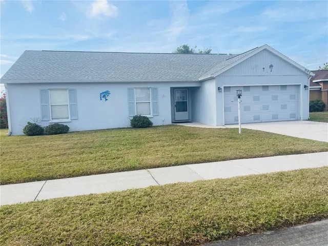 a view of a house with a yard and garage