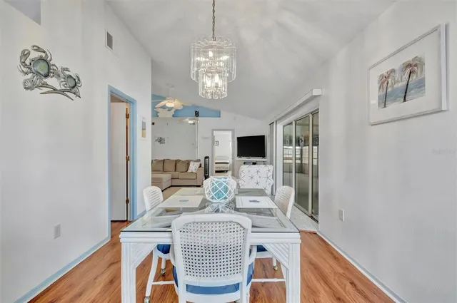 a view of a dining room with furniture and a chandelier