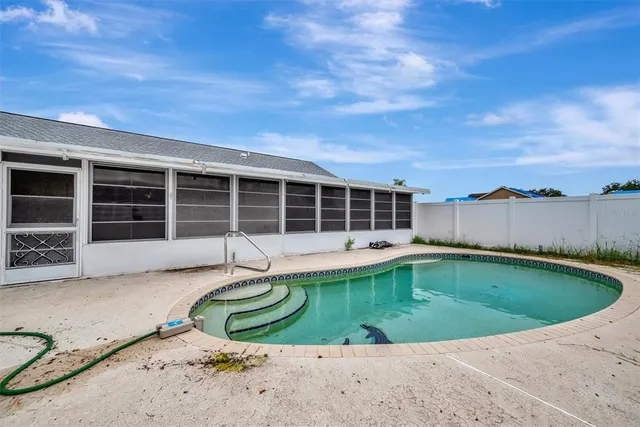 a view of a house with a swimming pool and a yard